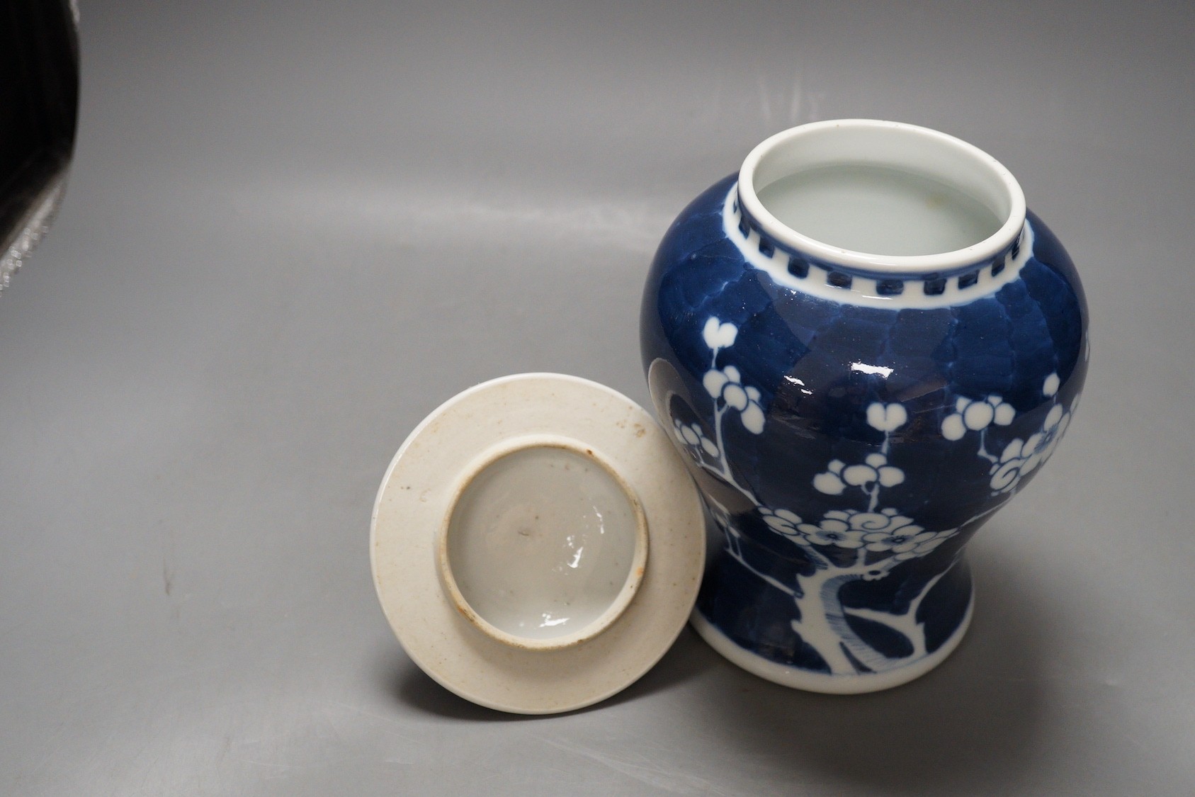 An early 20th century Chinese blue and white prunus vase and cover, 23cm